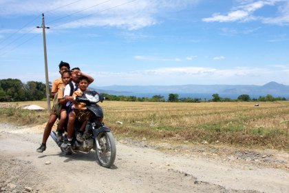 Photo of a group of people riding on the back of a motorcycle, Indonesia, August 2014, Reinder Nijhoff