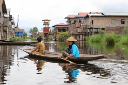 Photo of two people in a small boat on a river, Myanmar, India, Nepal, June 2015, Reinder Nijhoff