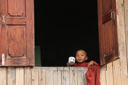Photo of a little boy that is looking out of a window, Myanmar, India, Nepal, June 2015, Reinder Nijhoff