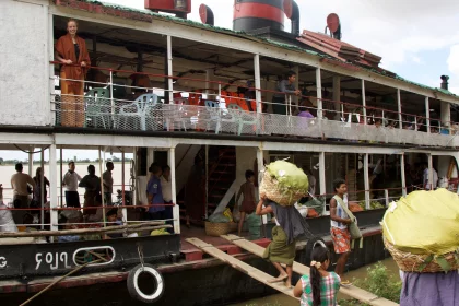 Photo of a group of people standing on the deck of a boat, Myanmar, India, Nepal, June 2015, Reinder Nijhoff