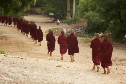 Photo of a group of monks walking down a dirt road, Myanmar, India, Nepal, June 2015, Reinder Nijhoff