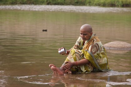 Photo of a person sitting in a body of water, Myanmar, India, Nepal, June 2015, Reinder Nijhoff