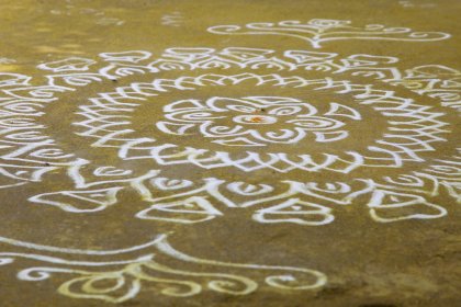 Photo of a close up of a person's hand drawing on the ground, Myanmar, India, Nepal, June 2015, Reinder Nijhoff