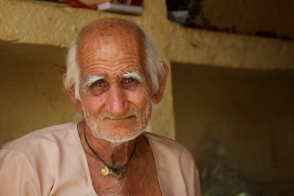 Photo of an old man with white hair wearing a necklace, Myanmar, India, Nepal, June 2015, Reinder Nijhoff