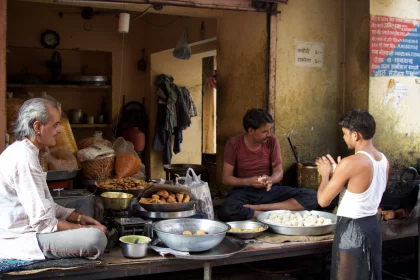 Photo of a group of people sitting around a table filled with food, Myanmar, India, Nepal, June 2015, Reinder Nijhoff