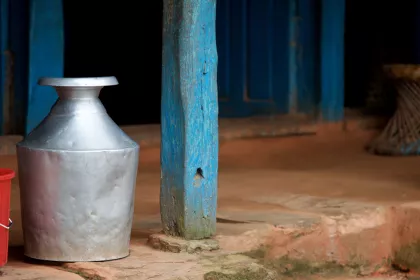 Photo of a silver vase sitting next to a red bucket, Myanmar, India, Nepal, June 2015, Reinder Nijhoff