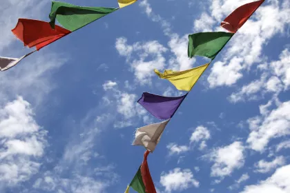 Photo of a group of colorful flags flying in the sky, Myanmar, India, Nepal, June 2015, Reinder Nijhoff