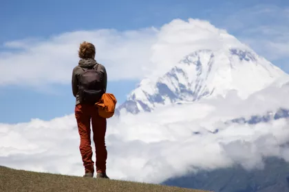 Photo of a person standing on top of a hill with a backpack, Myanmar, India, Nepal, June 2015, Reinder Nijhoff