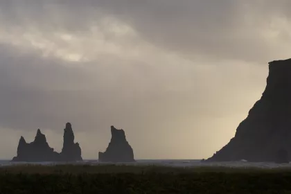 Photo of a group of rocks sitting on top of a beach under a cloudy sky, Iceland, September 2015, Reinder Nijhoff