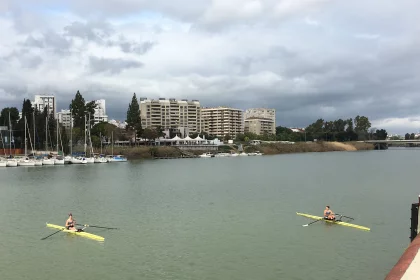 Photo of two people in kayaks paddling on the water, Seville, February 2016, Reinder Nijhoff