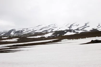 Photo of a man riding skis down a snow covered slope, Iceland, June 2016, Reinder Nijhoff