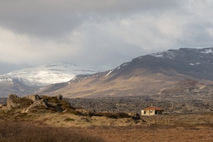 Photo of a house in the middle of a field with mountains in the background, Iceland, May 2017, Reinder Nijhoff
