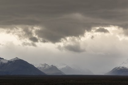 Photo of a field with mountains in the background under a cloudy sky, Iceland, May 2017, Reinder Nijhoff