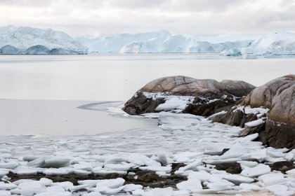 Photo of a large body of water surrounded by snow covered rocks, Greenland, October 2017, Reinder Nijhoff