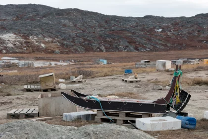Photo of a boat sitting on top of a pile of rocks, Greenland, October 2017, Reinder Nijhoff