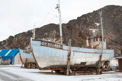 Photo of a boat sitting on top of a snow covered ground, Greenland, October 2017, Reinder Nijhoff