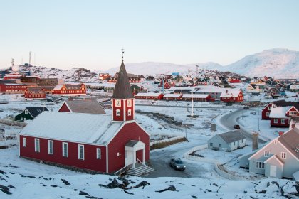 Photo of a small town with a red church in the middle of it, Greenland, October 2017, Reinder Nijhoff