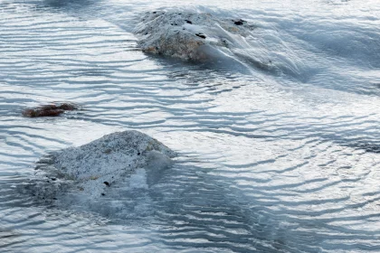 Photo of a couple of rocks sitting in the middle of a body of water, Greenland, October 2017, Reinder Nijhoff