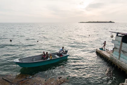 Photo of a small boat in the water next to a dock, Santa Cruz del Islote, Colombia, December 2017, Reinder Nijhoff