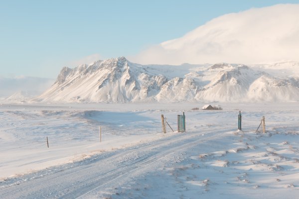 Photo of a snow covered road with a mountain in the background, Winter Iceland, January 2018, Reinder Nijhoff