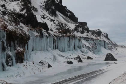 Photo of a road that is next to a mountain covered in ice, Winter Iceland, January 2018, Reinder Nijhoff
