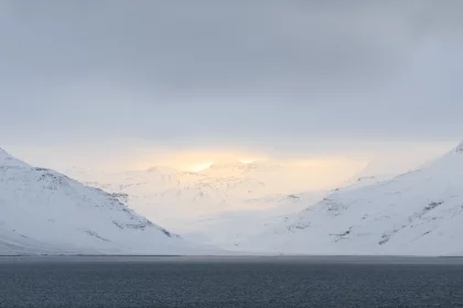 Photo of a large body of water surrounded by snow covered mountains, Winter Iceland, January 2018, Reinder Nijhoff