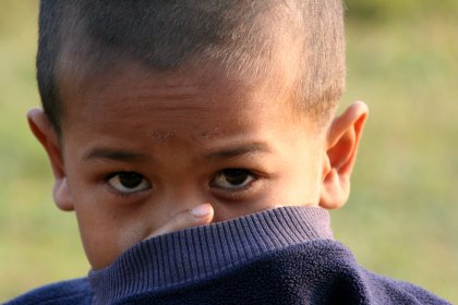 Photo of a young boy with a finger on his nose, Thailand, Laos, Cambodja & Vietnam, November 2005, Reinder Nijhoff