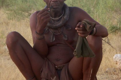 Photo of a man sitting on the ground smoking a cigarette, Namibia, May 2008, Reinder Nijhoff