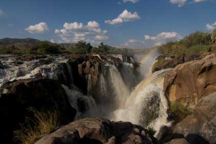 Photo of a waterfall with a rainbow in the middle of it, Namibia, May 2008, Reinder Nijhoff