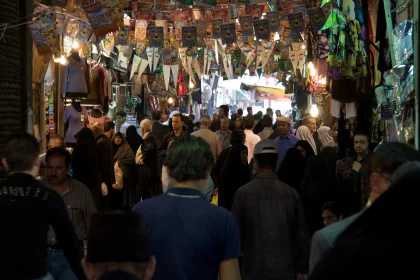 Photo of a crowd of people walking down a street at night, Jordan, Syria, Lebanon, May 2009, Reinder Nijhoff