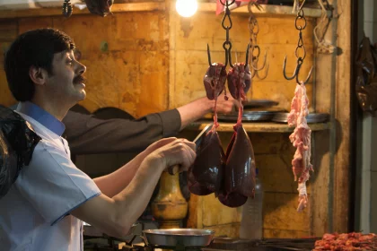 Photo of a man standing in a kitchen preparing food, Jordan, Syria, Lebanon, May 2009, Reinder Nijhoff